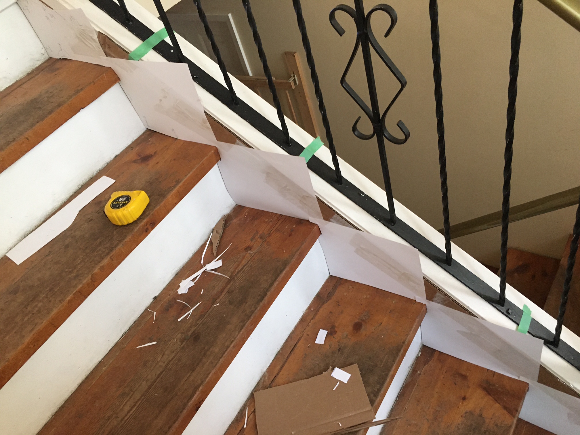 flooring - Should a skirt board on a stair case be installed over the  treads? - Home Improvement Stack Exchange